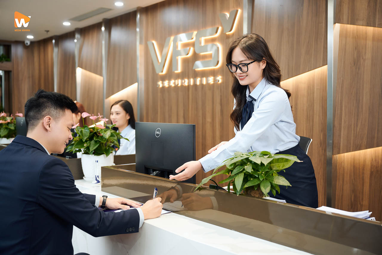 Nhân viên VFS Securities hướng dẫn khách hàng làm thủ tục tại quầy